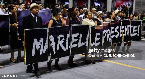 Revellers of the "Vai-Vai" samba school hold a banner honouring slain Rio de Janeiro councilwoman Marielle Franco as they perform during the second...