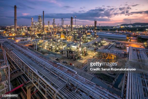 oil refinery during sunset - oil refinery stock pictures, royalty-free photos & images