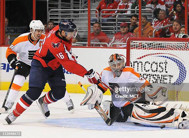 The Philadelphia Flyers goalie Sergei Bobrovsky stops a scoring attempt by the Washington Capitals' Eric Fehr , as Flyers captain Mike Richards,...