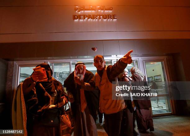 Palestinians Muslim pilgrims are led to board a bus at the Rafah border crossing between the Gaza Strip and Egypt on March 3 before crossing to...