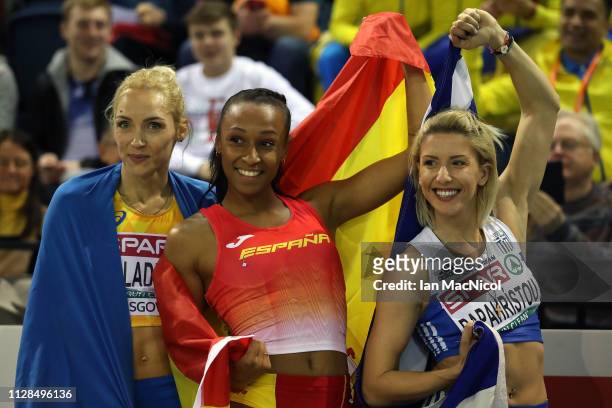 Olha Saladukha of Ukraine, Ana Peleteiro of Spain and Paraskevi Papahristou of Greece celebrate winning medals during the final of the women's triple...