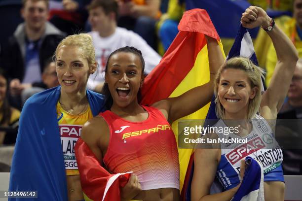 Olha Saladukha of Ukraine, Ana Peleteiro of Spain and Paraskevi Papahristou of Greece celebrate winning medals during the final of the women's triple...