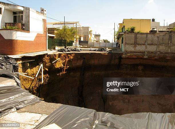 Foot deep sinkhole opened up May 31 at an intersection in Guatemala City after heavy rains. The sinkhole is among a series of disasters -- both...