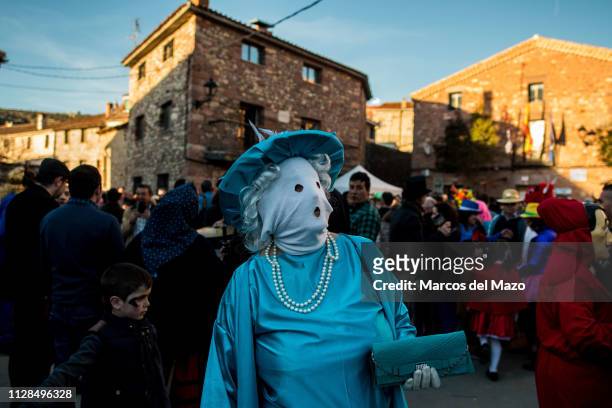 Woman with her face covered with a mask during a traditional carnival festival. Every year Luzon hosts a carnival festival named 'Diablos y...