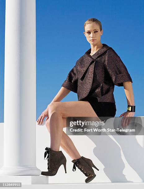 Glimmering brightly against winter's backdrop is an Escada mauve-and-black metallic weave short swing jacket with a generous portrait collar , paired...