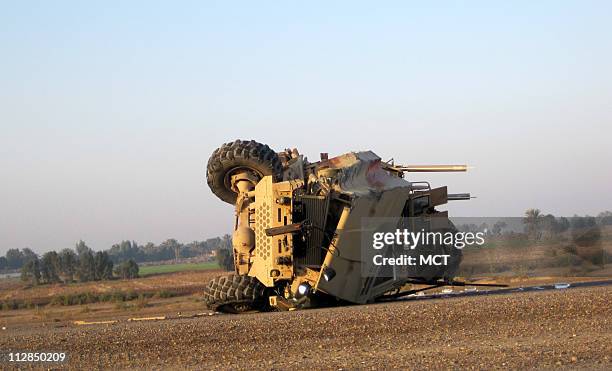 Armored vehicle known as an MRAP is overturned on the side of a highway south of Baghdad on Wednesday, January 6 after a deadly collision with an...