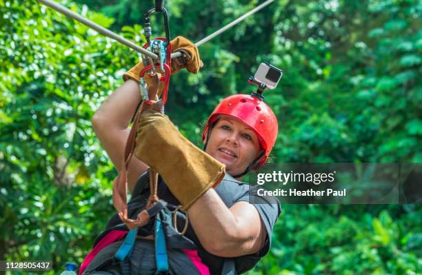 smiling woman zip lining in the mountains - dominican republic stock pictures, royalty-free photos & images