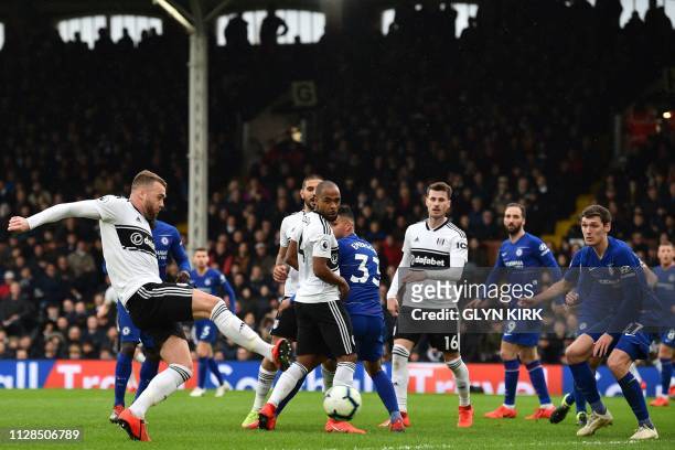 Fulham's English defender Calum Chambers shoots to score their first goal during the English Premier League football match between Fulham and Chelsea...