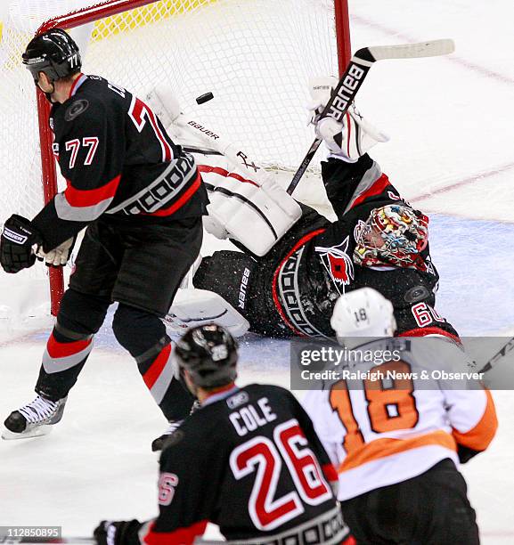 The Philadelphia Flyers' Mike Richards puts the puck past the Carolina Hurricanes' Joe Corvo , Erik Cole and goalie Justin Peters for a third-period...