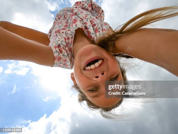 smiling young girl from directly below while doing handstand - directly below stock pictures, royalty-free photos & images