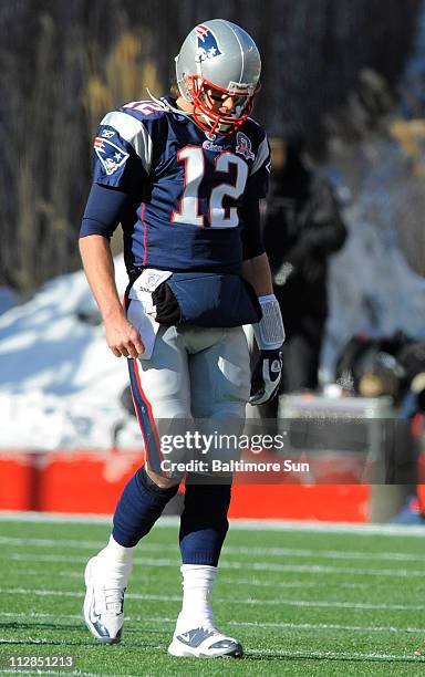 New England Patriots' quarterback Tom Brady walks off the field after throwing an interception during the first half of an AFC Wild Card playoff game...