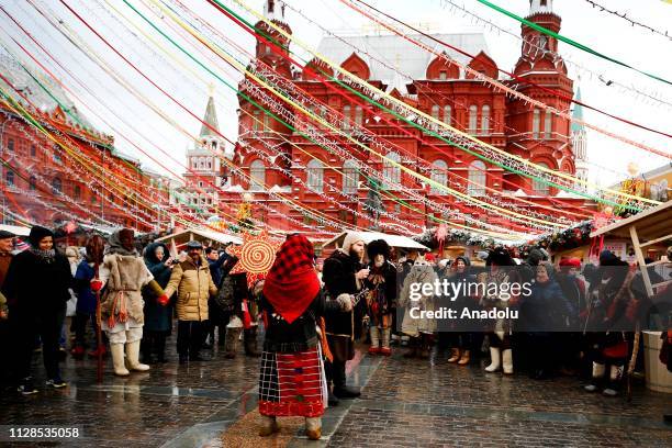 Performers in scary masks entertain the public during the Maslenitsa festival [Pancake Week] that celebrates the end of winter and marks the arrival...