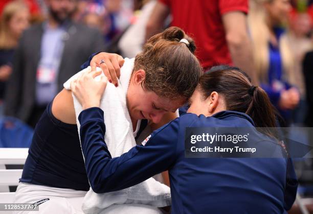 An emotional Johanna Konta of Great Britain is consoled by a member of the coaching staff after winning her match during Day Four of the Fed Cup...