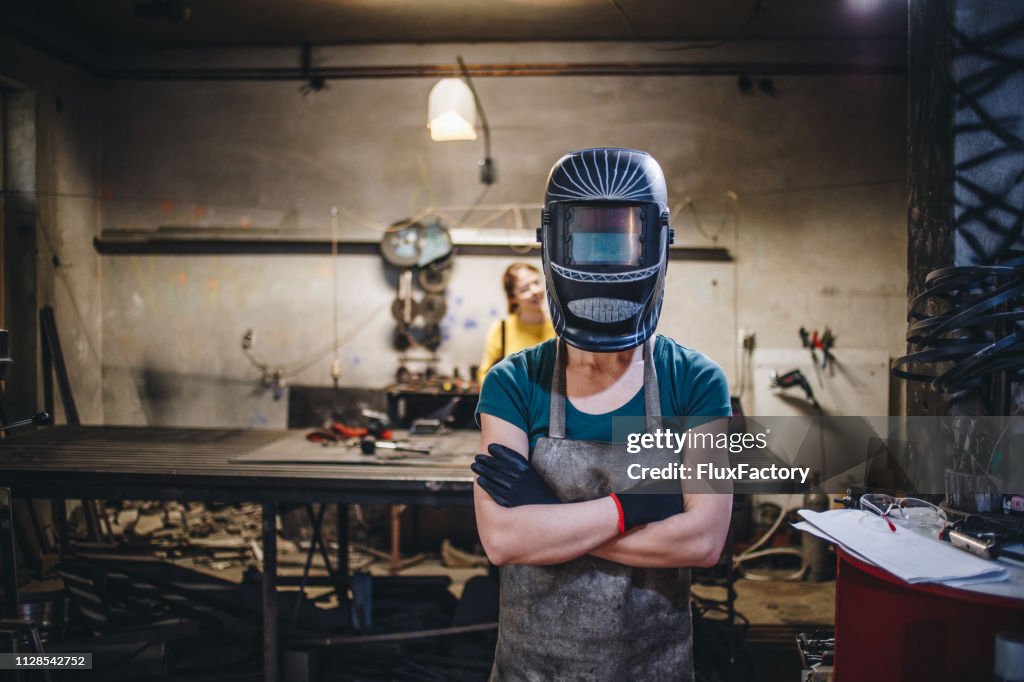 Female siblings in a welding shop