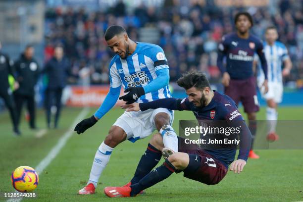 Sead Kolasinac of Arsenal gets hurt tackling Elias Kachunga of Huddersfield Town during the Premier League match between Huddersfield Town and...