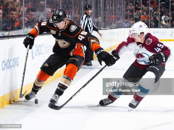 Max Jones of the Anaheim Ducks and Samuel Girard of the Colorado Avalanche battle for the puck during the first period of the game at Honda Center on...