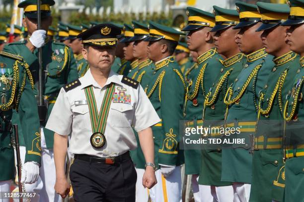 General Koji Yamazaki , chief of staff of Japan's Ground Self-Defense Force, inspects an honour guard at a welcoming ceremony at the Philippine army...