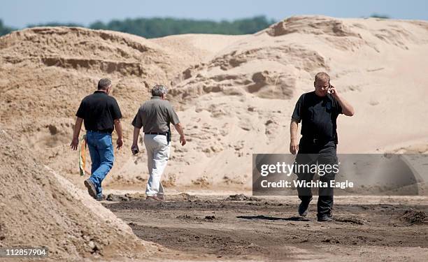 Law enforcement investigators work the scene at an asphalt plant southwest of Great Bend, Kansas, August 25 where a body was found. Kansas Attorney...