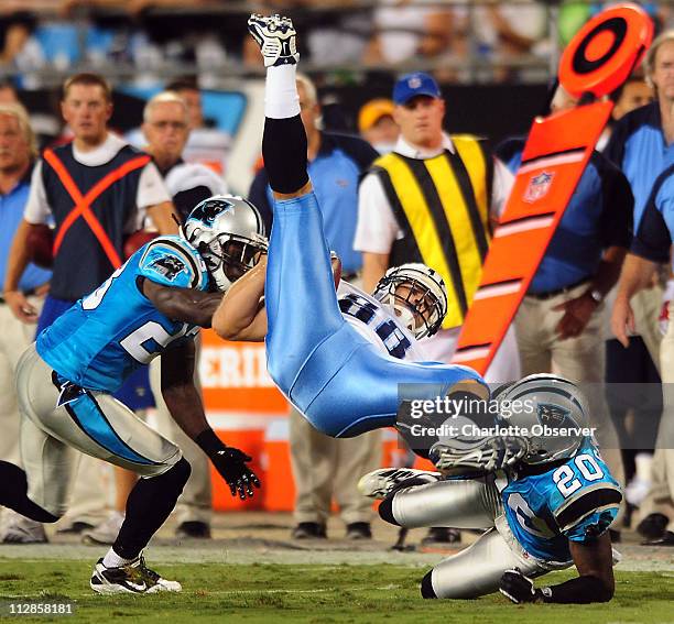 Carolina Panthers safety Sherrod Martin and cornerback Chris Gamble upend Tennessee Titans tight end Craig Stevens following a pass reception during...