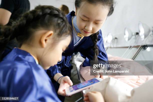 Model prepares backstage for Amelie Wang during New York Fashion Week: The Shows at Industria Studios on February 09, 2019 in New York City.