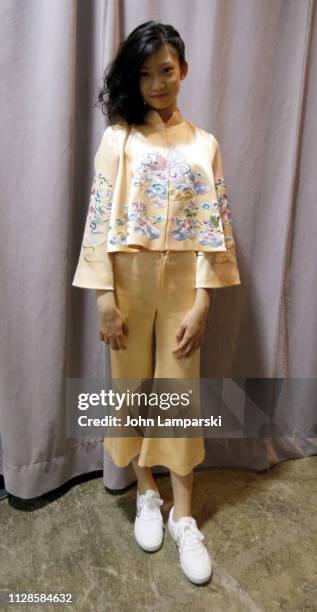 Model prepares backstage for Amelie Wang during New York Fashion Week: The Shows at Industria Studios on February 09, 2019 in New York City.