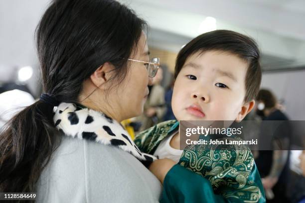 Model prepares backstage for Amelie Wang during New York Fashion Week: The Shows at Industria Studios on February 09, 2019 in New York City.