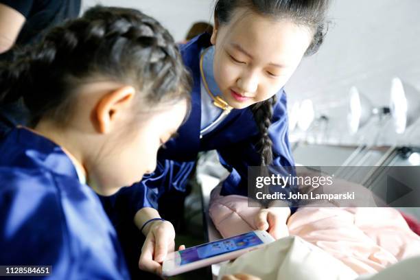 Model prepares backstage for Amelie Wang during New York Fashion Week: The Shows at Industria Studios on February 09, 2019 in New York City.