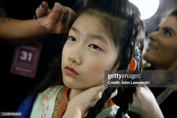 Model prepares backstage for Amelie Wang during New York Fashion Week: The Shows at Industria Studios on February 09, 2019 in New York City.