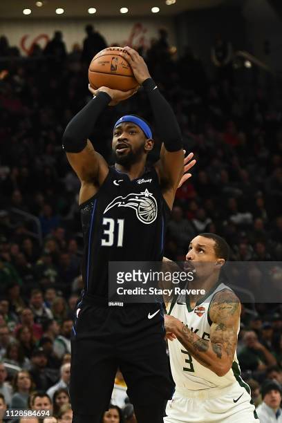 Terrence Ross of the Orlando Magic takes a shot in front of George Hill of the Milwaukee Bucks during the second half of a game at Fiserv Forum on...