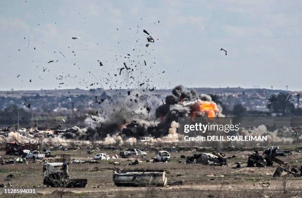 Smoke and fire billow after shelling on the Islamic State group's last holdout of Baghouz, in the eastern Syrian Deir Ezzor province on March 3,...