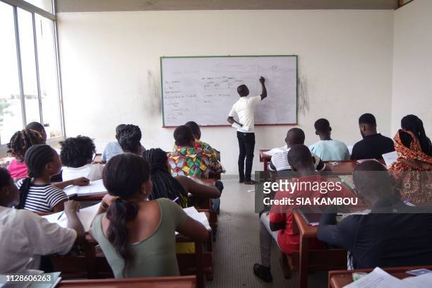 Teacher gives a lesson to students at Felix Houphouet-Boigny university in Abidjan as classes start again on March 4, 2019 after 6 weeks of strike by...
