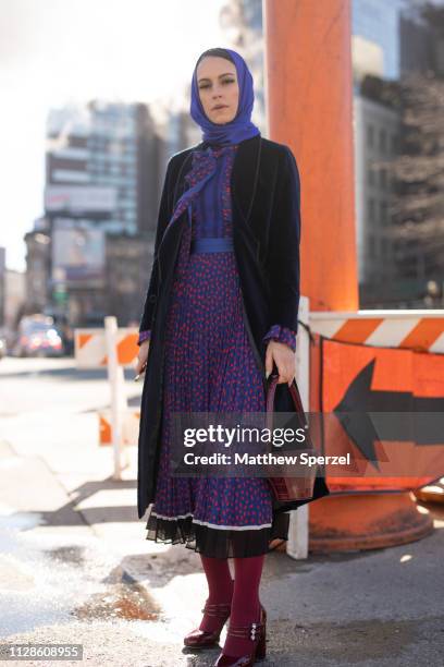 Mademoiselle Meme is seen on the street during New York Fashion Week AW19 wearing purple dress with royal blue hijab on February 09, 2019 in New York...