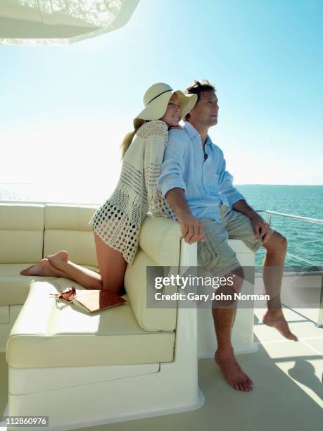 couple relaxing on yacht - alta società foto e immagini stock