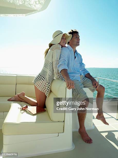 couple relaxing on yacht - high society stock pictures, royalty-free photos & images