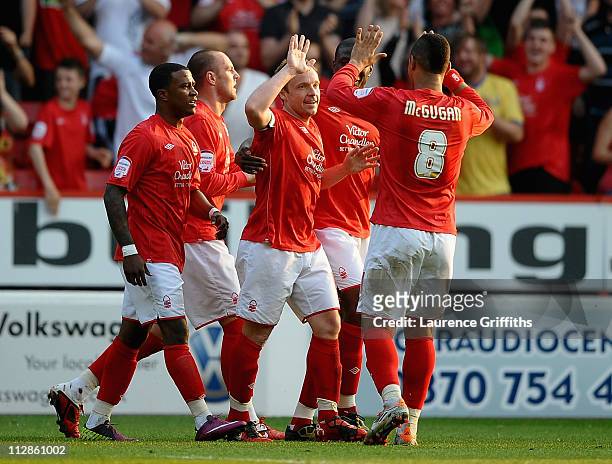 Paul McKenna of Nottingham Forest is congratulated by team-mate Lewis McGugan after scoring the 3-2 goal during the npower Championship match between...