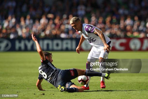 Jason Davidson of the Glory is tackled by Terry Antonis of the Victory during the round 18 A-League match between the Melbourne Victory and the Perth...