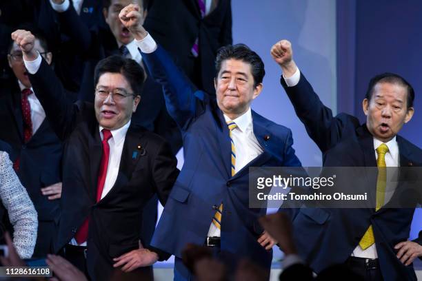 Japanese Prime Minister and Liberal Democratic Party President Shinzo Abe raises his arm with other party members at the party's annual convention on...