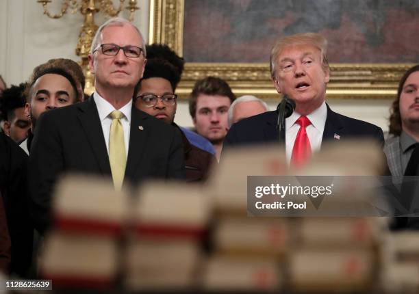 President Donald Trump speaks behind a table full of McDonald's hamburgers, Chick fil-a sandwiches and other fast food as he welcomes the 2018...