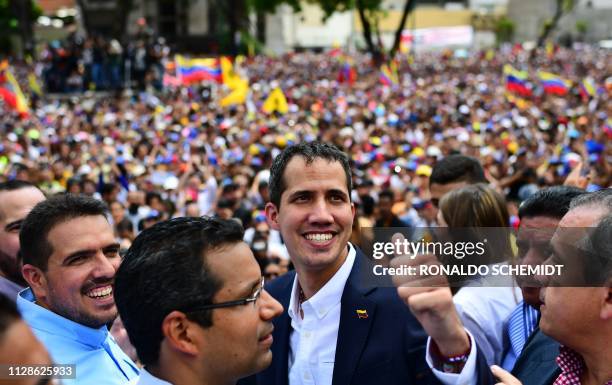 Venezuelan opposition leader and self-proclaimed acting president Juan Guaido gives the thumb up during a rally upon his arrival in Caracas on March...