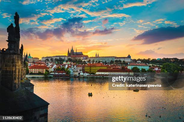 view of charles bridge in prague during sunset, river vltava czech republic. - castelo de hradcany imagens e fotografias de stock