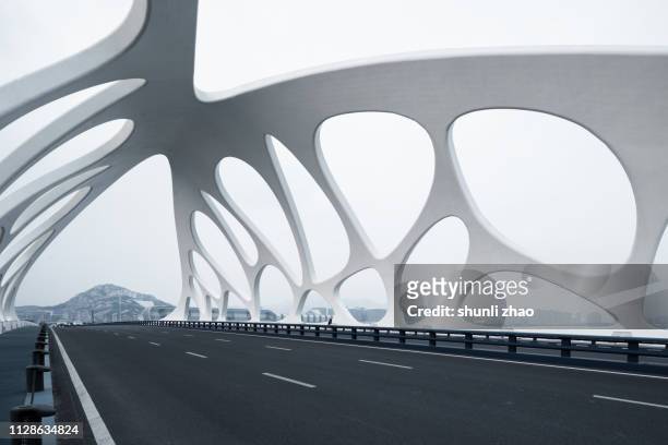 moern bridge with strange structures, qingdao - bridge built structure stock pictures, royalty-free photos & images