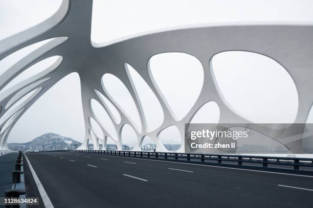 moern bridge with strange structures, qingdao - qingdao stock pictures, royalty-free photos & images