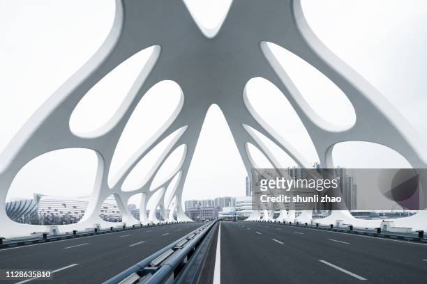 moern bridge with strange structures, qingdao - qingdao stock-fotos und bilder