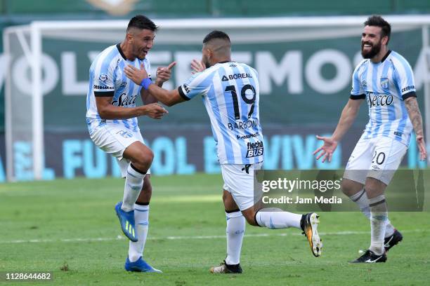 Gervasio Nuñez of Atletico Tucuman celebrates with teammates David Barbona and Jose San Roman after scoring his side's second goal during a match...