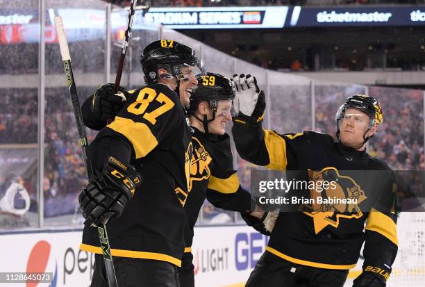 Sidney Crosby, Jake Guentzel and Patric Hornqvist of the Pittsburgh Penguins celebrate Crosby's goal in the first period during the 2019 Coors Light...