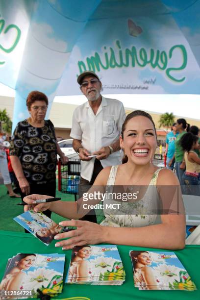 Singer Denise Gonzalez signs autographs for fans as she promotes her music CD and 7UP on Friday, July 31 in Miami, Florida. An increasing number of...
