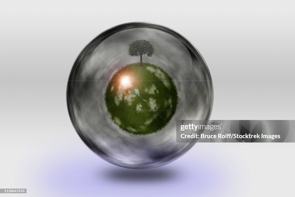 Green globe inside transparent container.