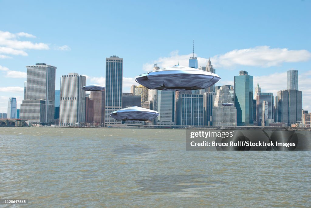 Flying saucers over New York harbor. 3D Rendering