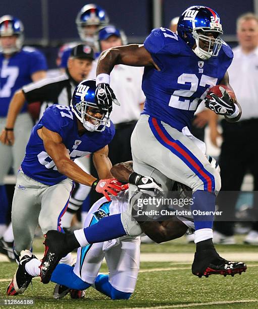 New York Giants running back Brandon Jacobs powers past Carolina Panthers cornerback Richard Marshall during first half action. The Giants faced the...