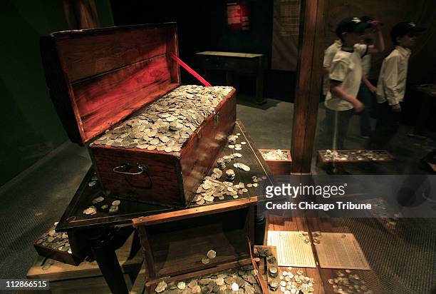 Pirates' treasure coins sit on display at an exhibit of the 18th century pirate ship Whydah at the Field Museum, February 24 in Chicago, Illinois. It...